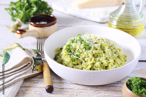 Italian cuisine. Parsley risotto, olive oil and Parmesan cheese