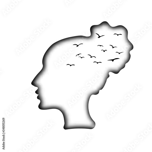 White paper head of a young beautiful girl, pattern with black silhouettes of birds. The dream of freedom, longing, melancholy. The wind in your hair. Romantic mood, autumn.
