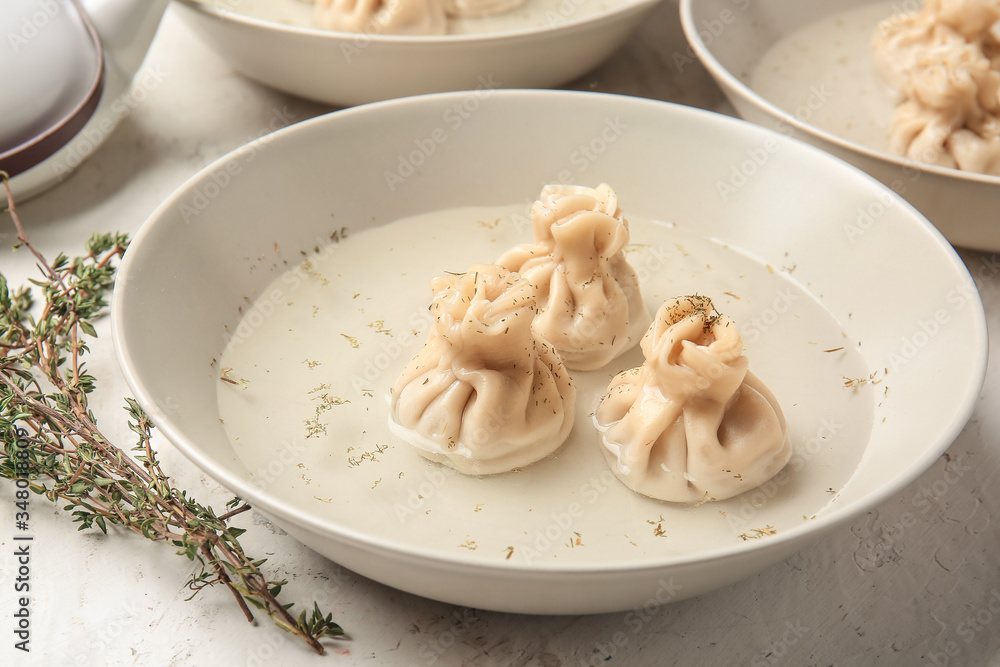 Plate with tasty dumplings on table