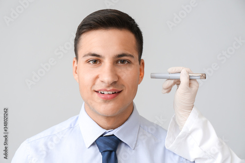 Otolaryngologist with flash...