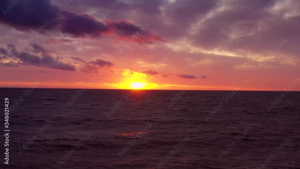 Majestic Sunrise, Sandycove, March 2020, Dublin, Ireland, Drone tracks sideways over the sea looking towards Horizon. Majestic Sunrise, Sandycove, March 2020, Dublin, Ireland, Drone tracks sideways over the sea looking towards Horizon.