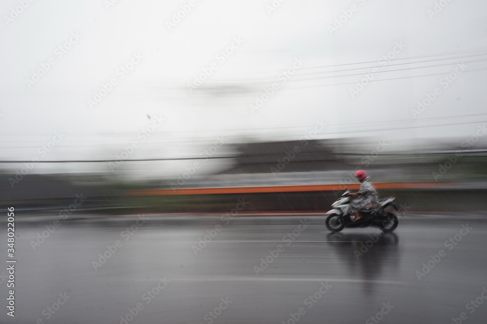 a motorcycle driver in the rain