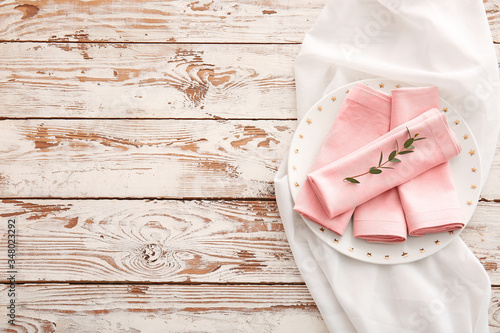 Beautiful table setting with floral decor on wooden background