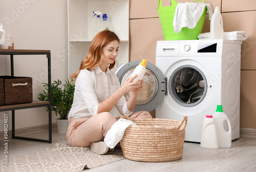 Beautiful woman doing laundry at home