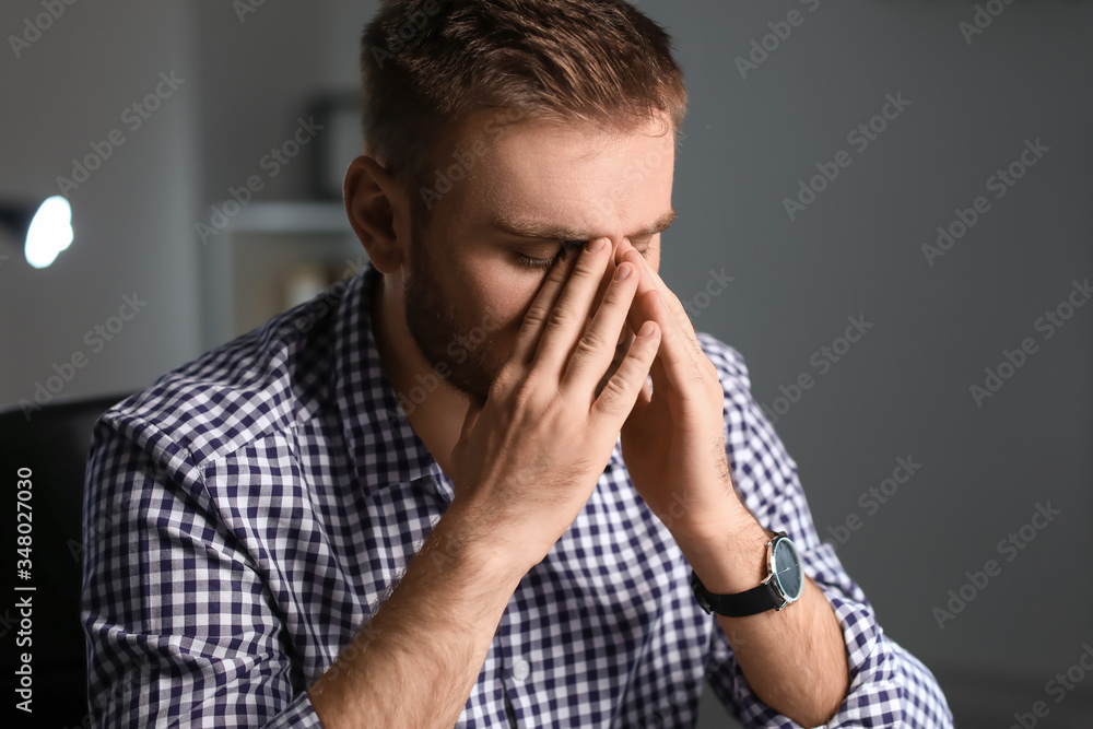 Tired businessman working in office late at night Tired businessman working in office late at night