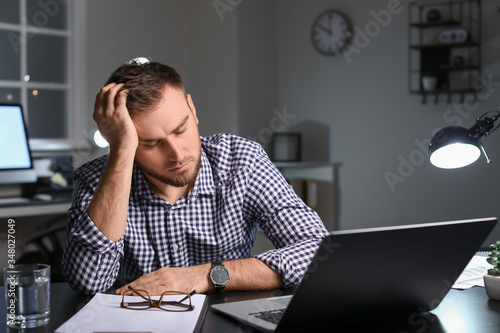 Tired businessman working i...