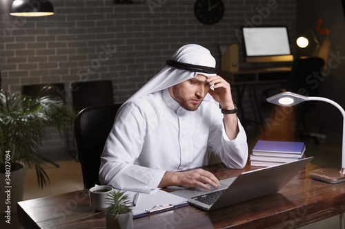 Arab businessman working in...