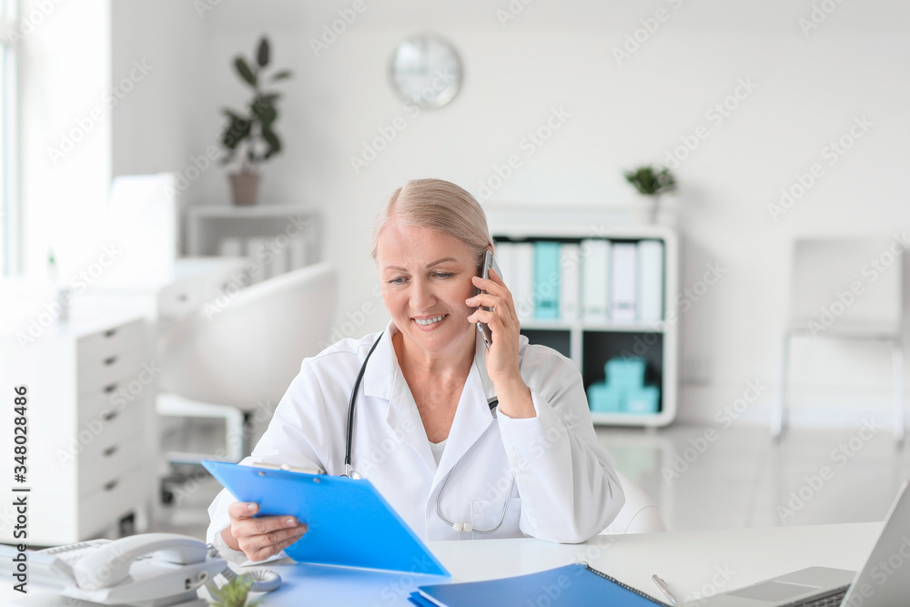 Fototapeta premium Mature female doctor working in clinic