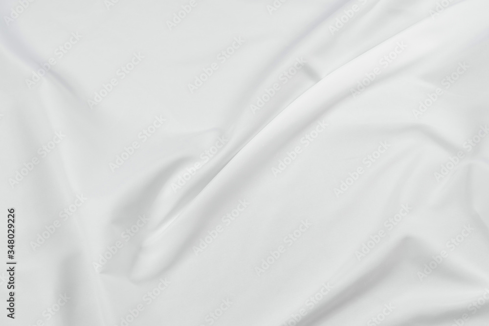 Abstract white fabric texture background. Cloth soft wave. Creases of satin, silk, and cotton. Abstract white fabric texture background. Cloth soft wave. Creases of satin, silk, and cotton.