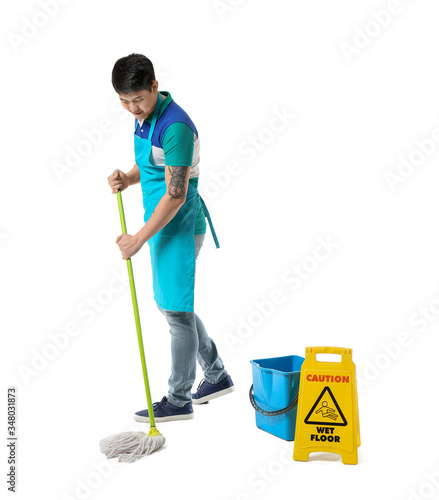 Young Asian man with mop an...