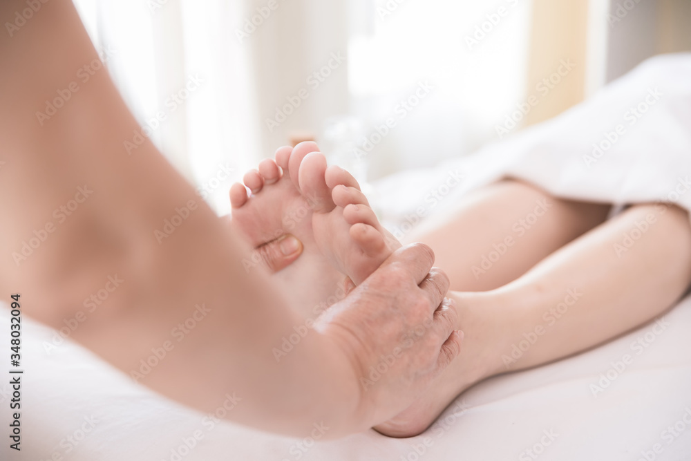 Close up Young woman getting Foot Reflexology massage at beauty spa salon. Massage for health Close up Young woman getting Foot Reflexology massage at beauty spa salon. Massage for health
