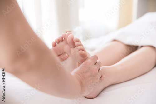 Close up Young woman getting Foot Reflexology massage at beauty spa salon. Massage for health © xreflex