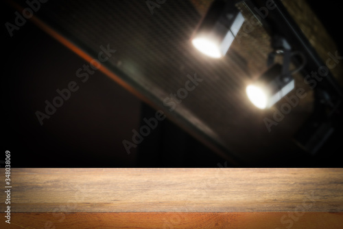 Wooden shelf table floor and wall dark blurred black spotlights, shelf display products. © Smile Studio AP