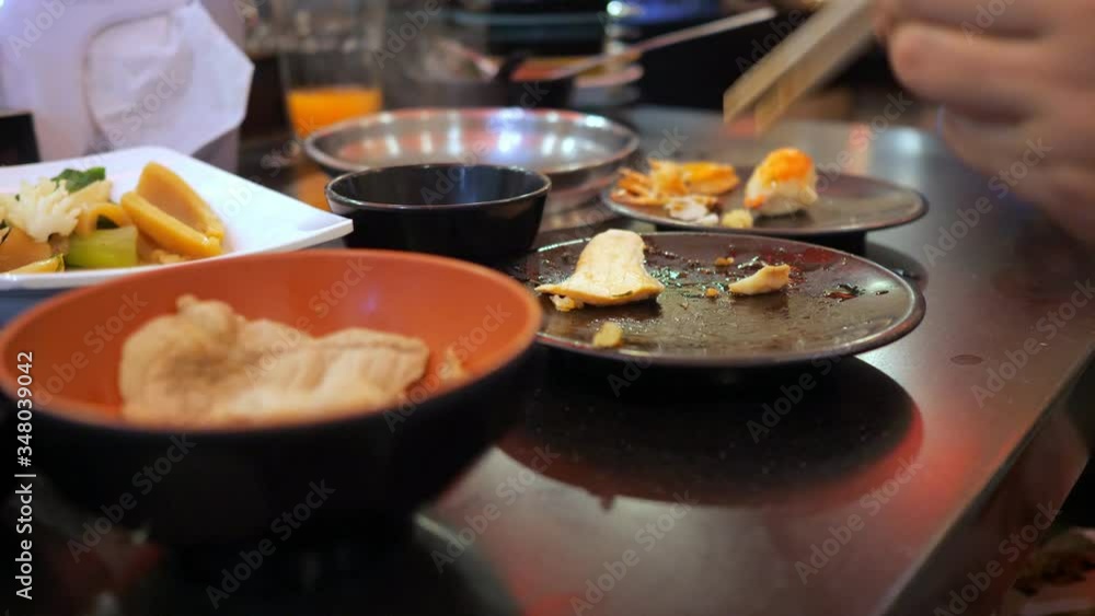 Unlimited buffet. Woman eating boiled fish with chopsticks. Unlimited buffet. Woman eating boiled fish with chopsticks.