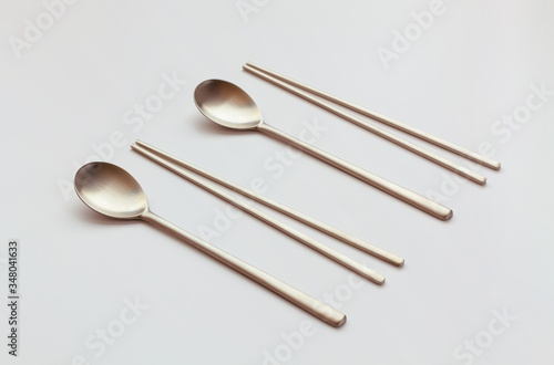 Korean high quality brass tableware. Spoons and chopsticks isolated on white background. 