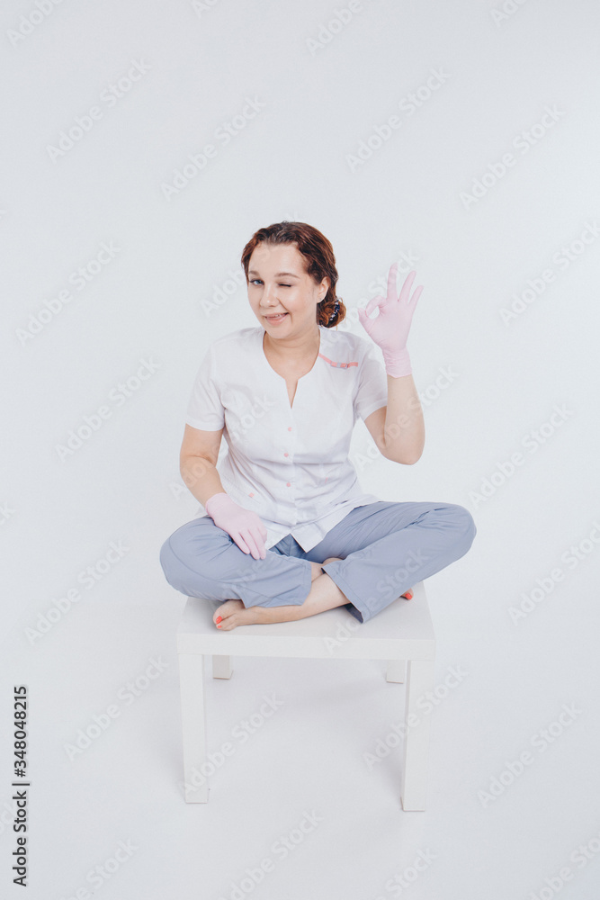 the doctor in rubber gloves shows that everything will be fine. Free medical care. Volunteers in the hospital. the girl wears a means of protection during the epidemic. Ads for antiseptics and medical