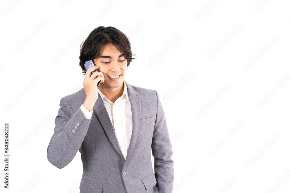 Isolated white background with clipping path and copy space of Asian businessman in grey suit talk with smile on his smartphone. Concept for working from home, social distancing, business negotiation Isolated white background with clipping path and copy space of Asian businessman in grey suit talk with smile on his smartphone. Concept for working from home, social distancing, business negotiation