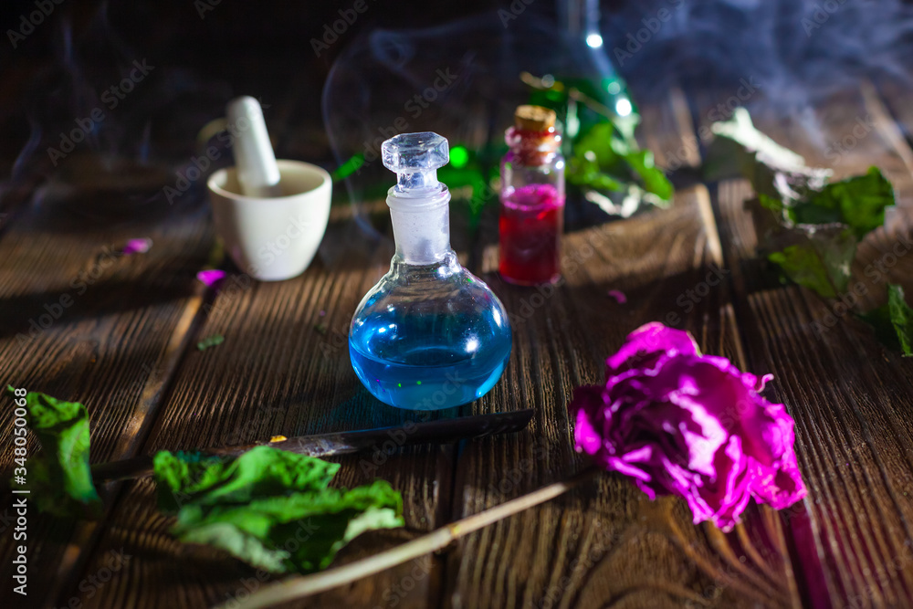 Witchcraft. Witch doctor desk table. Magic potion. ALternative medicine concept. Divination, love potion. Mysterious clouds of smoke. Witchcraft. Witch doctor desk table. Magic potion. ALternative medicine concept. Divination, love potion. Mysterious clouds of smoke.