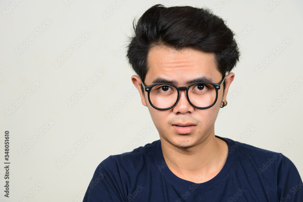 Portrait of young Asian nerd man with eyeglasses Portrait of young Asian nerd man with eyeglasses