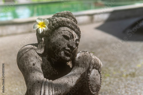 Grey Stone Statue with Flower in Ear