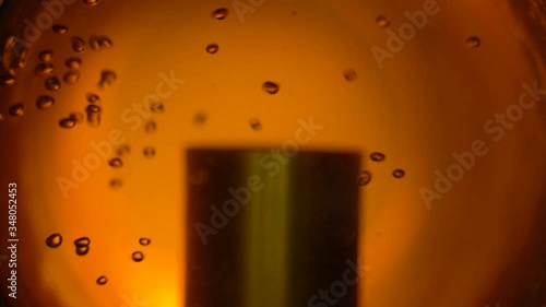 Beautiful process of filtering beer in the window. Close-up. Slow Motion.