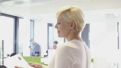 Senior woman working with her multi ethnic team in office
