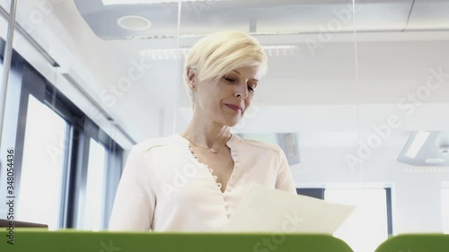 Senior woman working with her multi ethnic team in office
