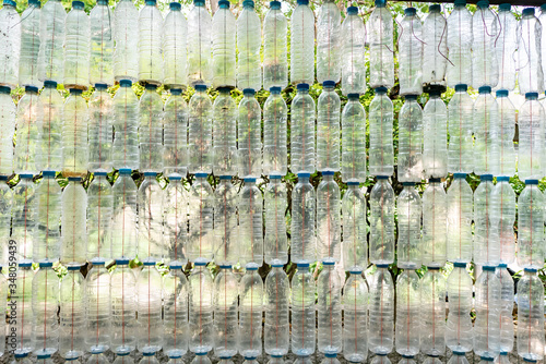 A wall made from used plastic bottles © wachiwit