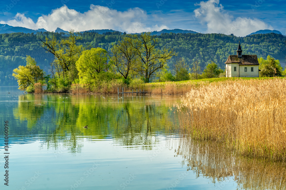 Fototapeta premium The historical St. Meinrad Chappel situated in an idyllic peninsula on the shores of the Upper Zurich Lake near Bollingen, st. Gallen, Switzerland