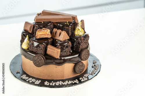 sweet triple chocolate cake with decoration on white background