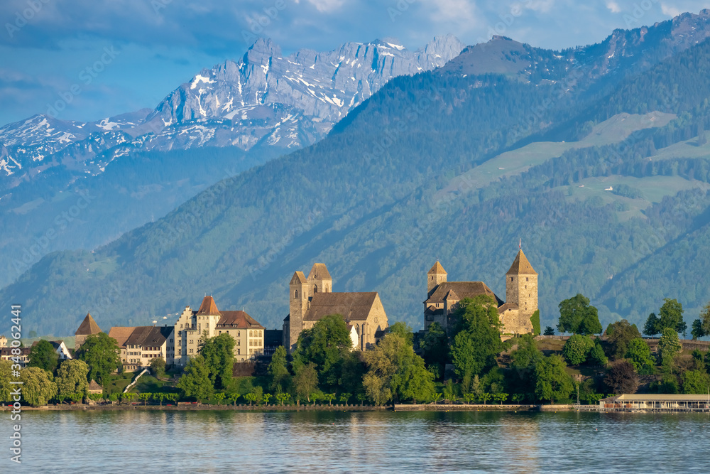 View of old city of Rapperswil dominated by its 13th century castle and the alps in the background, St. Gallen, Switzerland