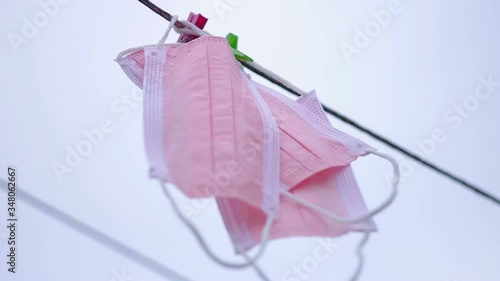 Three medical masks hang on a rope (bottom view)