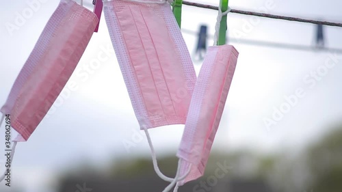 Three medical masks hang on a rope