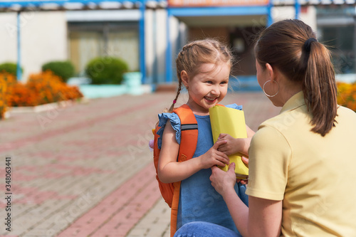 mother accompanies the child to school.