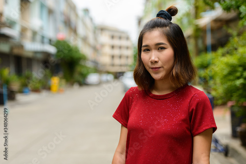 Portrait of young Asian woman with short hair outdoors © Ranta Images