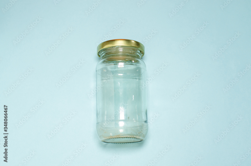 Transparent Glass jar on sky blue background Transparent Glass jar on sky blue background