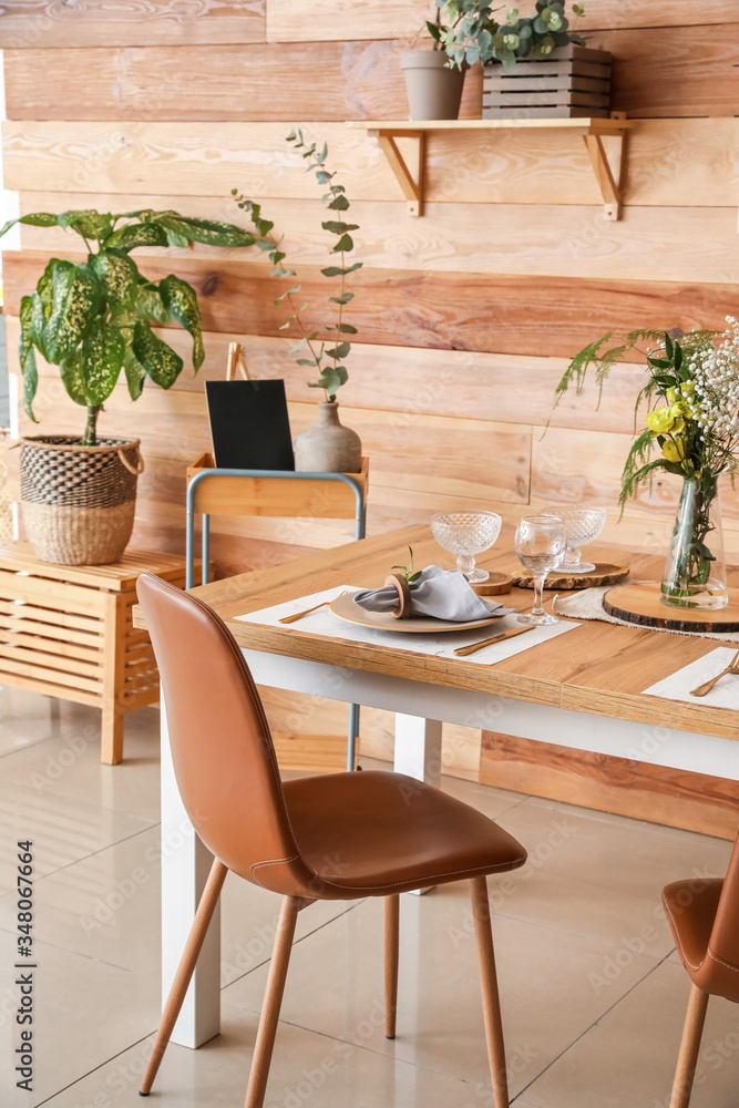 Interior of modern stylish dining room with floral decor Interior of modern stylish dining room with floral decor