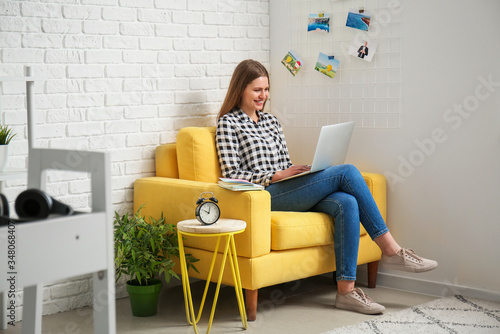Young woman with laptop wor...