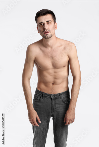 Young man with anorexia on color background