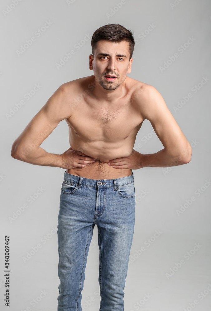 Young man with anorexia on grey background Young man with anorexia on grey background