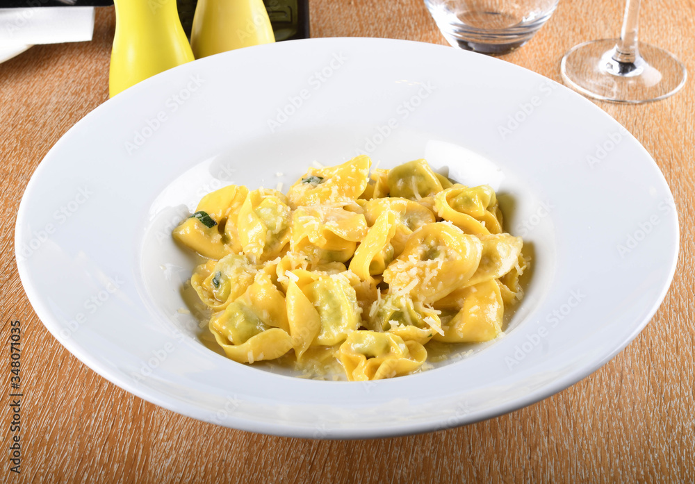 Tortellini with ricotta cheese and spinach, butter, sage sauce, grated parmesan. Parmigiano-Reggiano flakes Tortellini with ricotta cheese and spinach, butter, sage sauce, grated parmesan. Parmigiano-Reggiano flakes