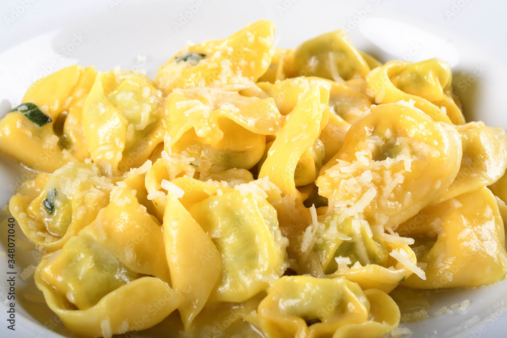 Tortellini with ricotta cheese and spinach, butter, sage sauce, grated parmesan. Parmigiano-Reggiano flakes Tortellini with ricotta cheese and spinach, butter, sage sauce, grated parmesan. Parmigiano-Reggiano flakes