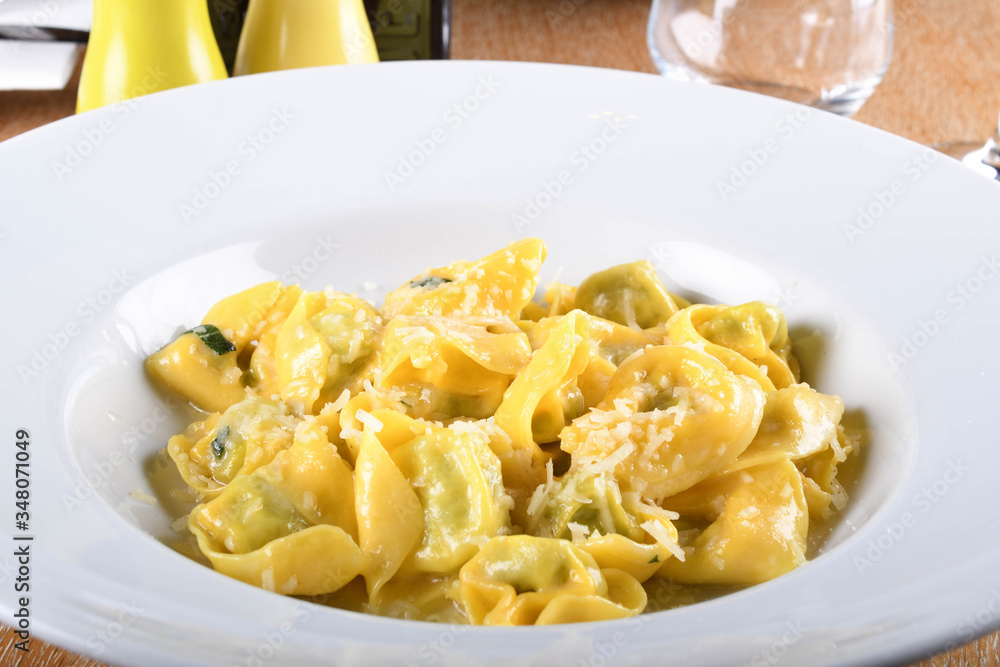 Tortellini with ricotta cheese and spinach, butter, sage sauce, grated parmesan. Parmigiano-Reggiano flakes Tortellini with ricotta cheese and spinach, butter, sage sauce, grated parmesan. Parmigiano-Reggiano flakes