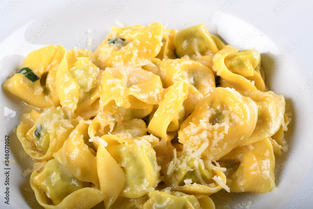 Tortellini with ricotta cheese and spinach, butter, sage sauce, grated parmesan. Parmigiano-Reggiano flakes Tortellini with ricotta cheese and spinach, butter, sage sauce, grated parmesan. Parmigiano-Reggiano flakes