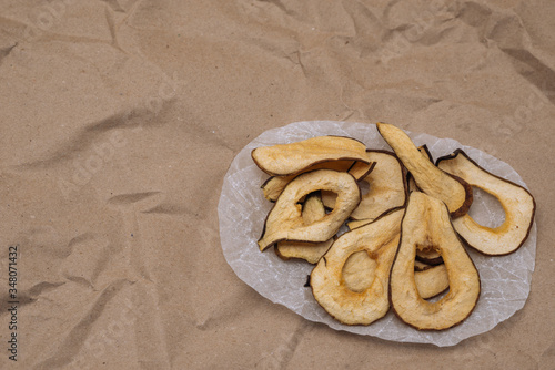 Vegetarian pear chips on craft background