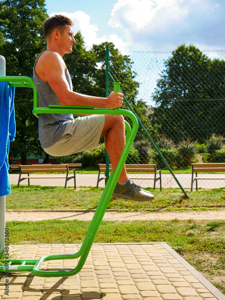 Fototapeta premium Man doing legs exercises in outdoor gym