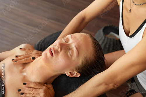 Spa Therapy. Woman Hands Massaging Girl’s Shoulders. Recovery And Relaxation Effect of Massage.