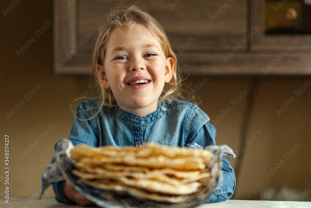 Favorite daughter. Happy little cute girl holding home pita (flat) bread in her hands. Cutie brought tortilla (lavash, naan) for mom. Favorite daughter. Happy little cute girl holding home pita (flat) bread in her hands. Cutie brought tortilla (lavash, naan) for mom.