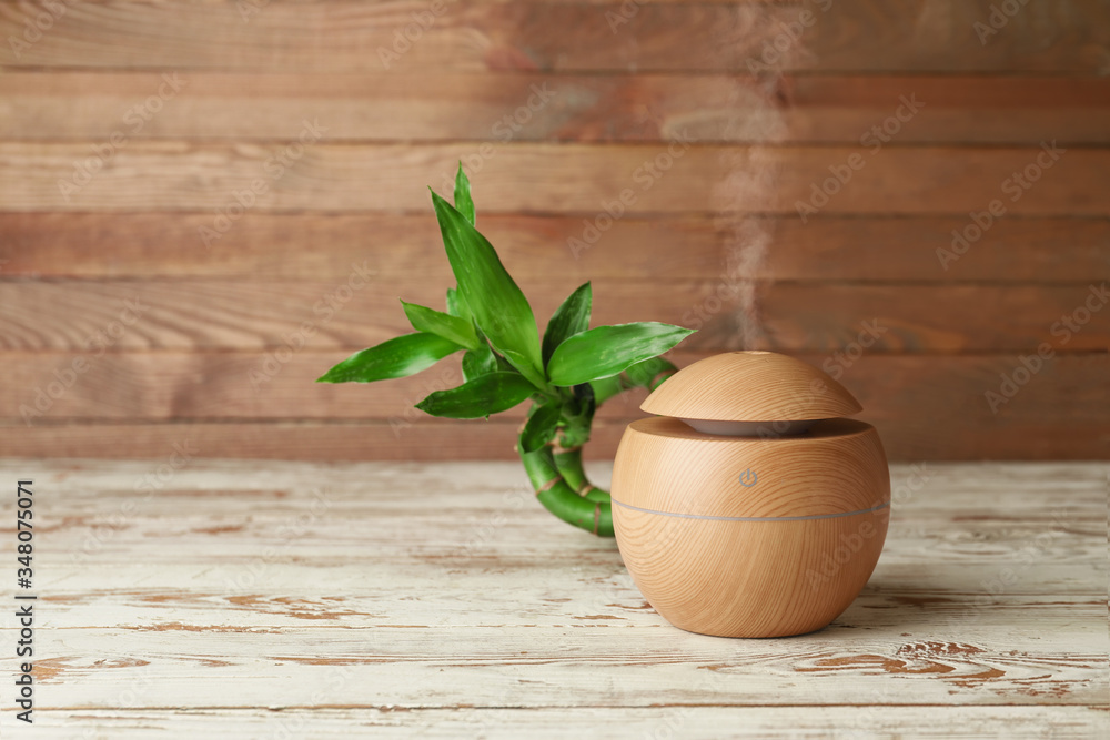 Aroma oil diffuser on wooden background Aroma oil diffuser on wooden background