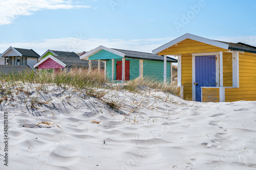 Candy coloured beach hut on Skanor beach in Falsterbo, Skane, Sweden. Swedish tourism concept photo